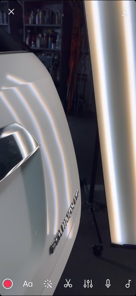 After PDR: white Equinox rear body panel, smooth paint with PDR light lines